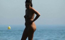 Slender cutie poses for a nudist beach voyeur